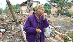 Na zdjęciu 82-letnia Raisa Kuwal w mieście Czuhujew w obwodzie charkowskim, przed budynkiem mieszkalnym zniszczonym przez Rosjan 16 lipca 2022, fot. SERGEY BOBOK / AFP